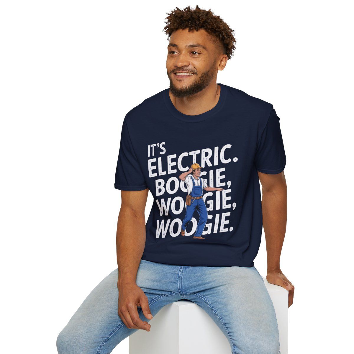 It's Electric Boogie Woogie T-shirt being worn by an African American model sitting ona white block.